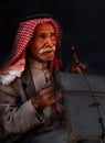 Little Petra, Jordan Ã¢â¬â June 20, 2017:Old Bedouin man or Arab man in traditional outfit, playing his musical instrument .